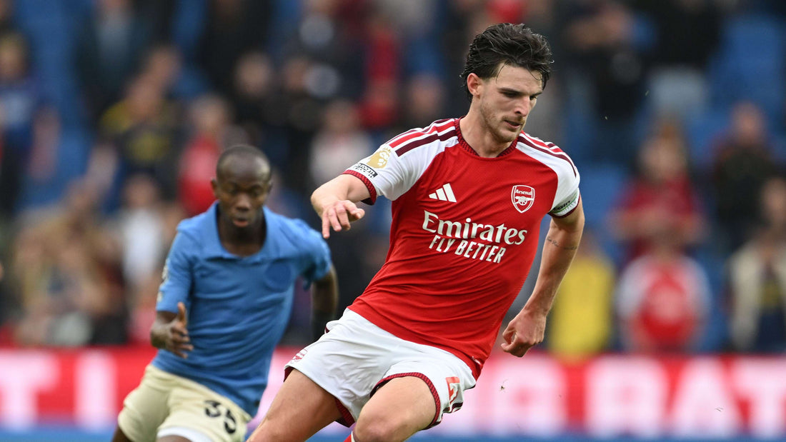 Declan Rice controlling the ball in Arsenal's red-and-white kit during a recent match
