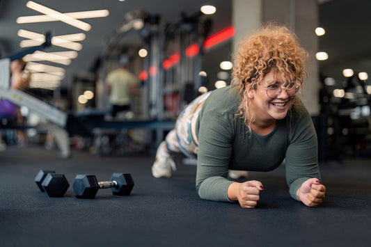 An athlete concentrating on a strength-training session in a gym rather than comparing themselves with other exercisers.