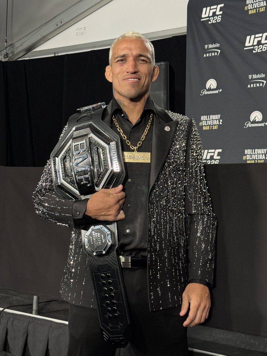 Charles Oliveira holding the BMF championship after UFC 326