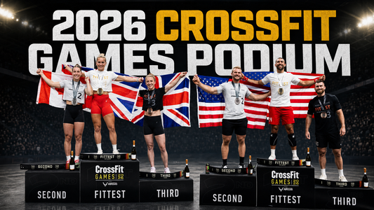 2026 CrossFit Games podium with Aimee Cringle and James Sprague celebrating with flags