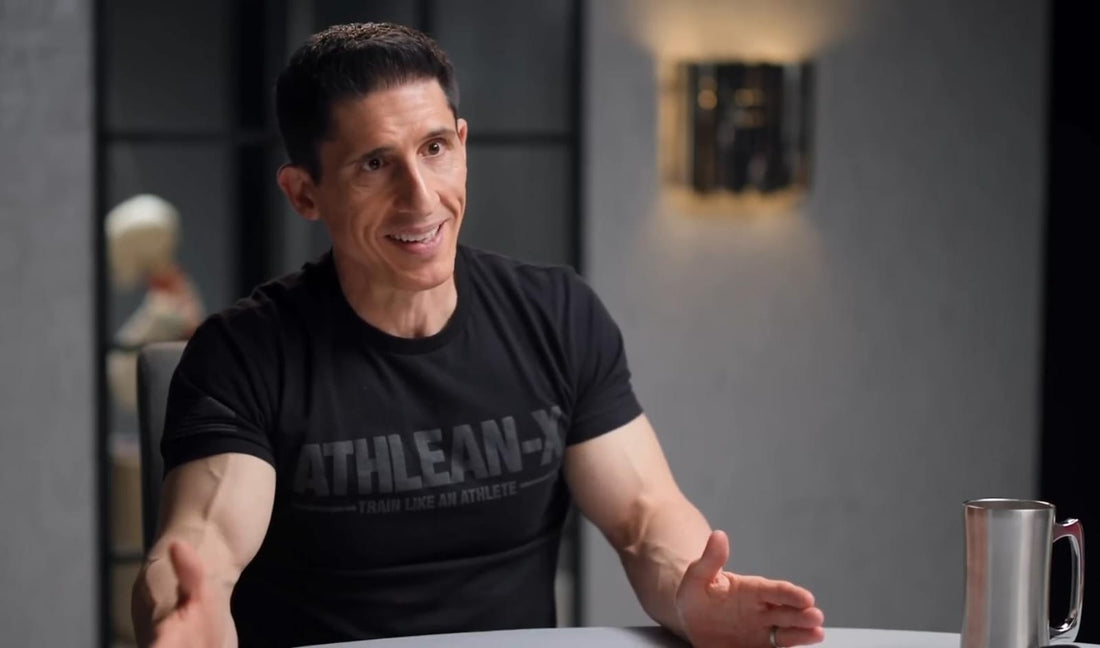 Jeff Cavaliere in an ATHLEAN-X shirt discussing strength training in a seated interview