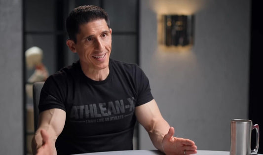 Jeff Cavaliere in an ATHLEAN-X shirt discussing strength training in a seated interview
