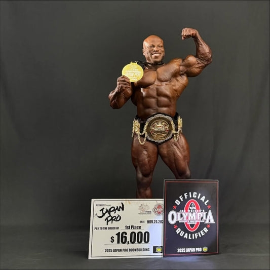 Shaun Clarida flexing onstage with a medal and winner's check after the 2025 Japan Pro Men's Open victory