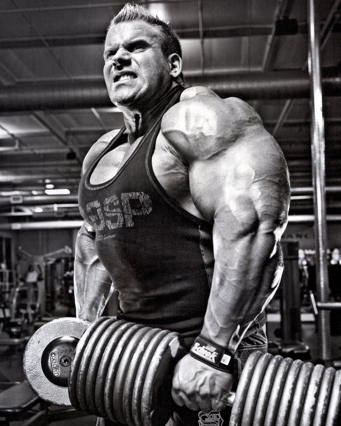 Jay Cutler focused and straining during a cable exercise in a bodybuilding gym