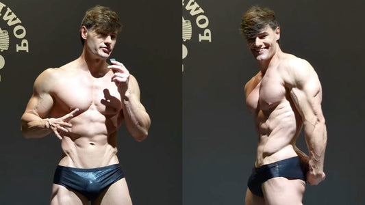 Jeff Seid posing on stage in Classic Physique trunks, showing chest, shoulders and leg development