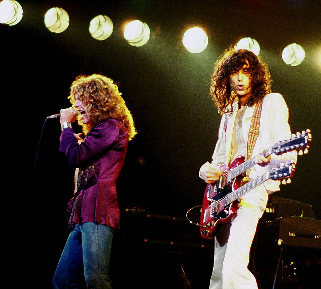 Robert Plant and Jimmy Page performing live with Led Zeppelin under stage lights
