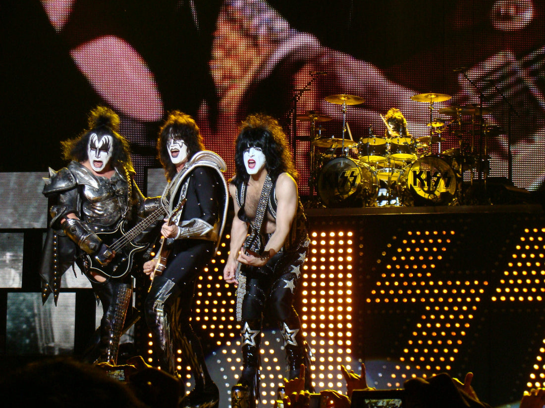 KISS band performing on stage in makeup, wide-legged stances and platform boots