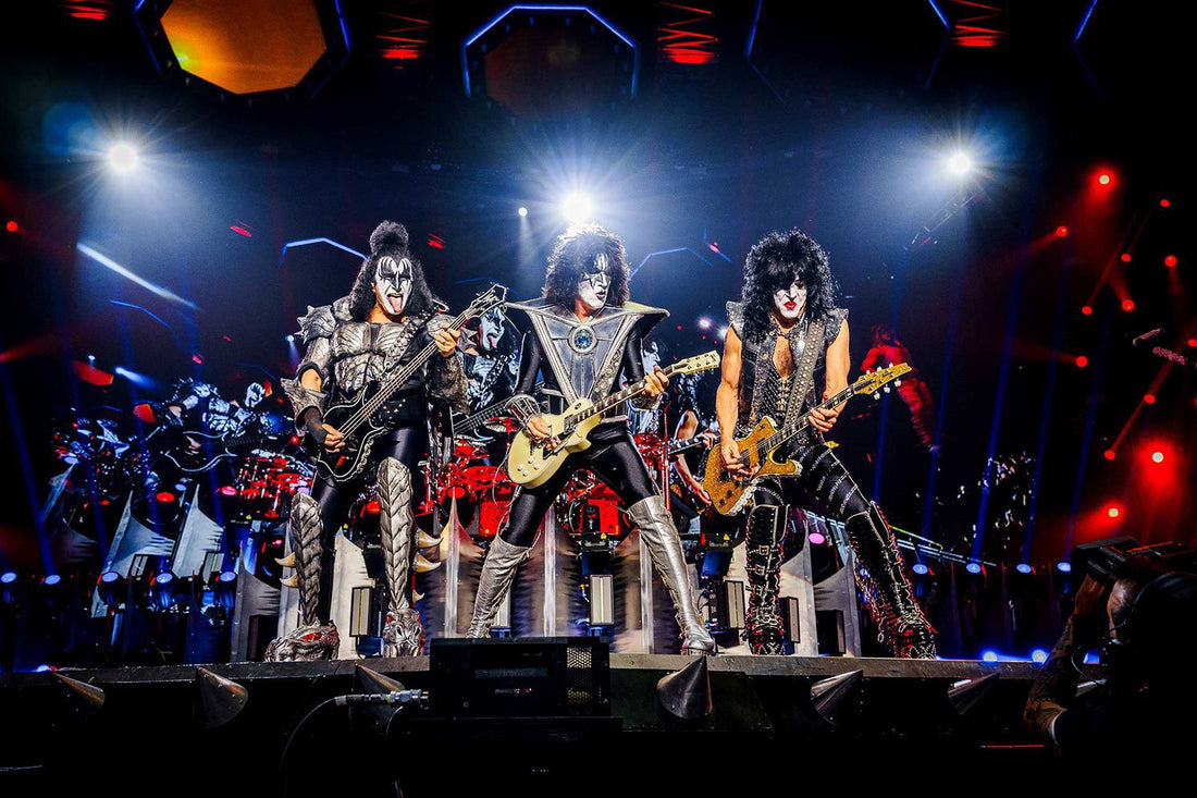 KISS performing live onstage with Gene Simmons, Paul Stanley and other band members playing guitars under bright concert lights