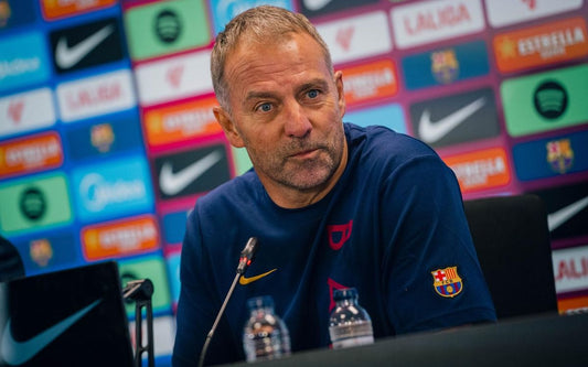 Hansi Flick addressing the press in Barcelona training attire on October 30 2026