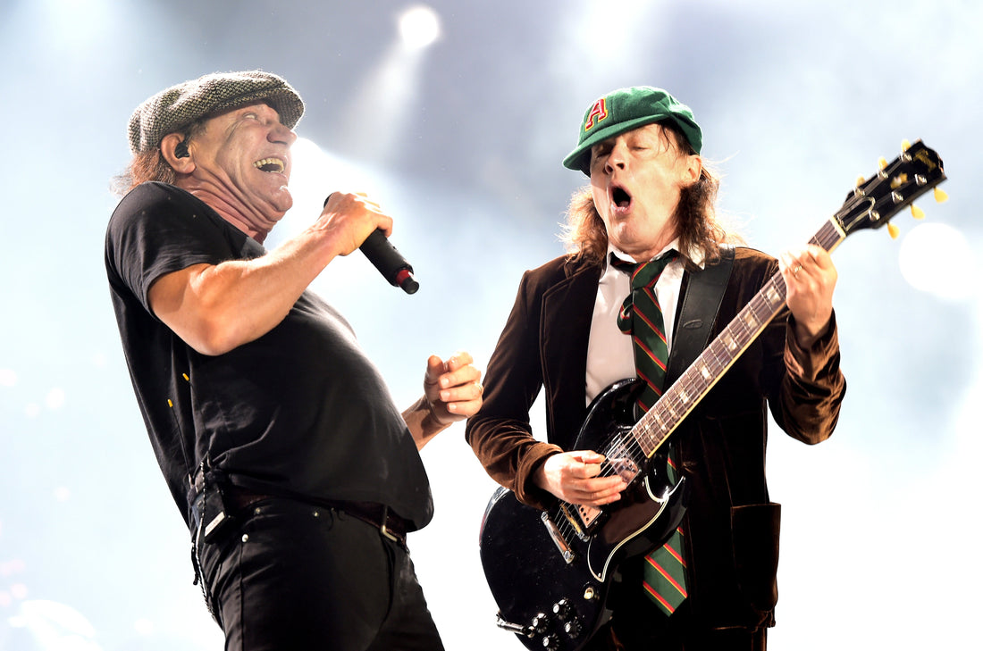 Angus Young and Brian Johnson of AC/DC performing energetically onstage