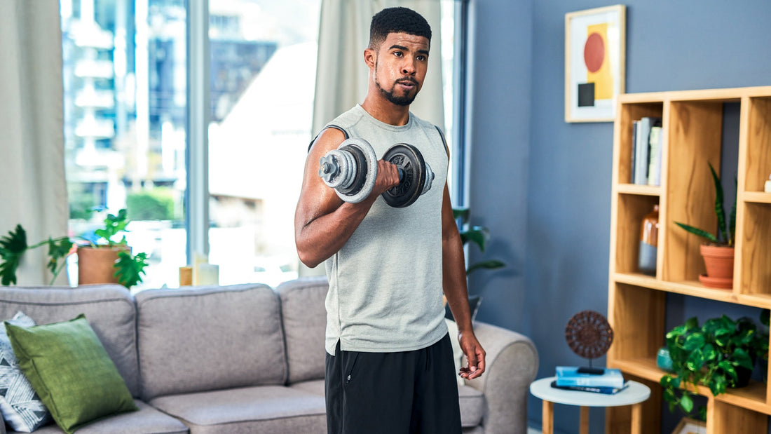 Man training at home with a single adjustable dumbbell held in one hand