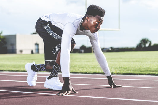 Runner preparing for cardiovascular training on an outdoor track