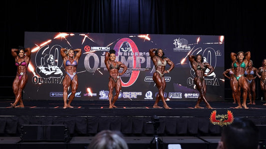 Elite female bodybuilders competing on the Ms. Olympia stage, showing muscular development and symmetry