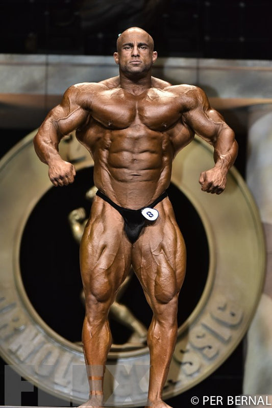 Fouad Abiad displaying his muscular physique on the 2017 Arnold Classic bodybuilding stage