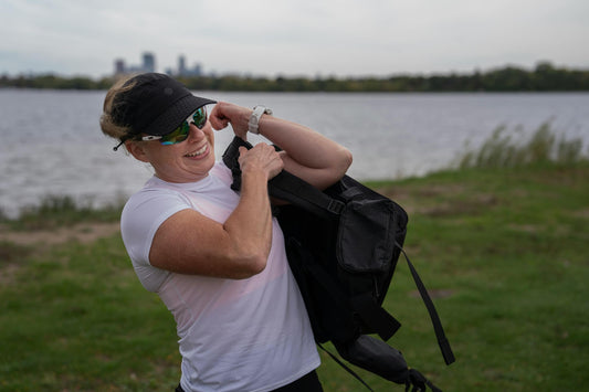 Megan Corey carrying a loaded 40-pound rucking backpack during an outdoor training session