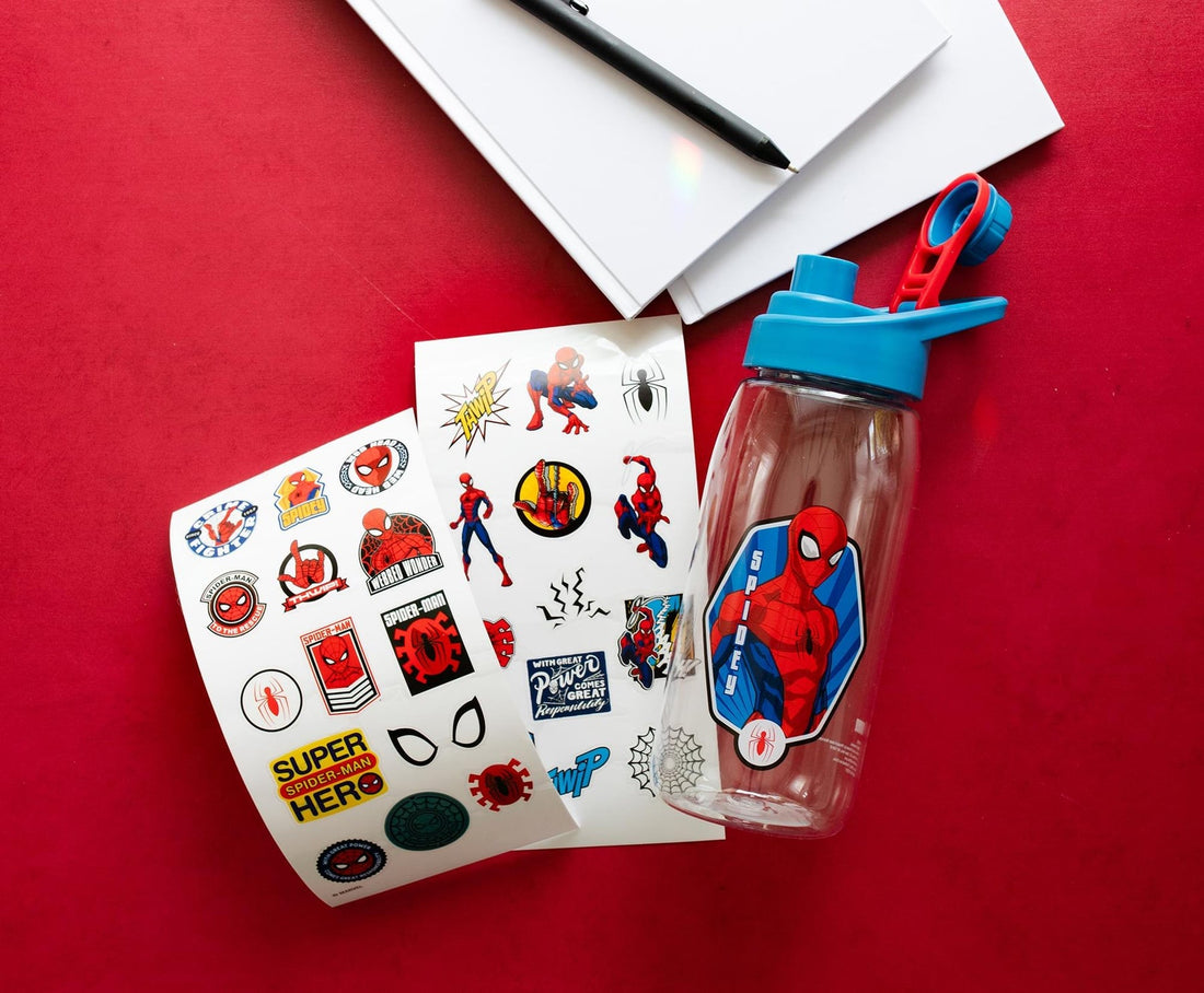 Spider-Man sports bottle beside sheets of red-and-blue superhero stickers