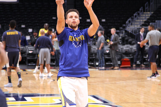 Stephen Curry warming up on a basketball court for the Golden State Warriors