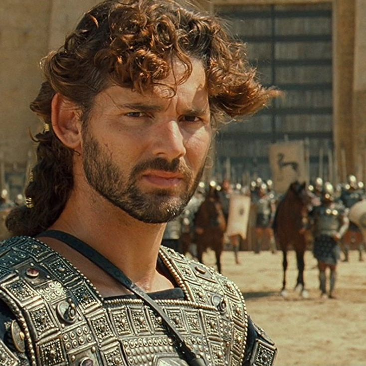 Eric Bana as Hector in Troy, wearing engraved bronze armor with soldiers behind him