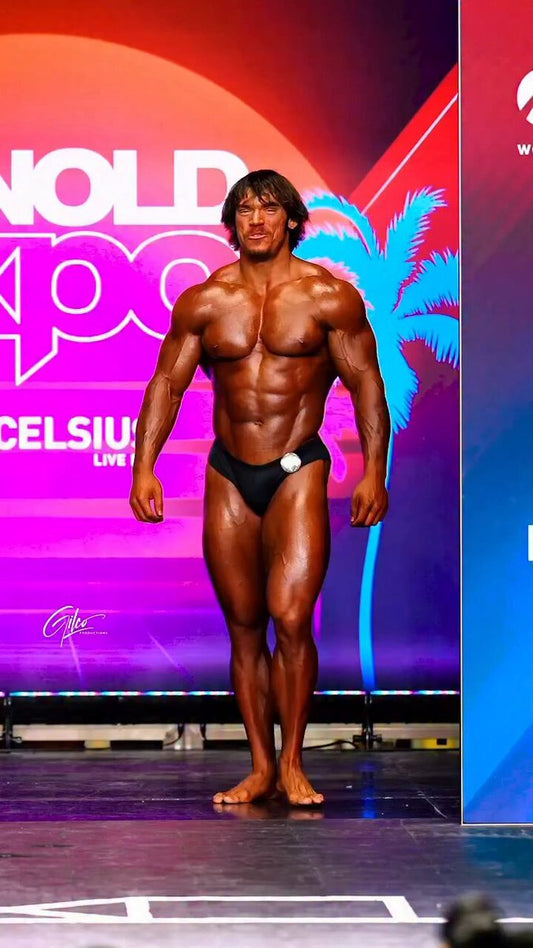 Sam Sulek posing during his transition from competitive diving to professional Classic Physique bodybuilding