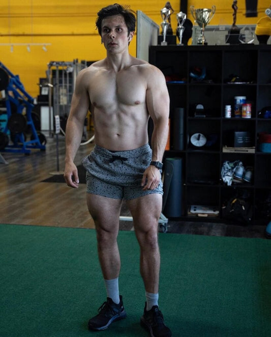 Will Tennyson standing shirtless in a gym showing a lean, balanced muscular physique