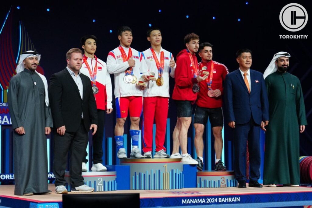 Medalists including Pak Pyol pose on the men's 67kg podium at the 2024 World Weightlifting Championships in Bahrain