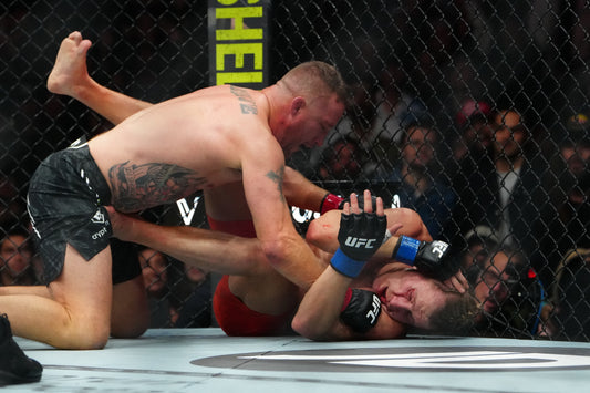Justin Gaethje and Paddy Pimblett grappling at UFC 324 in January 2026