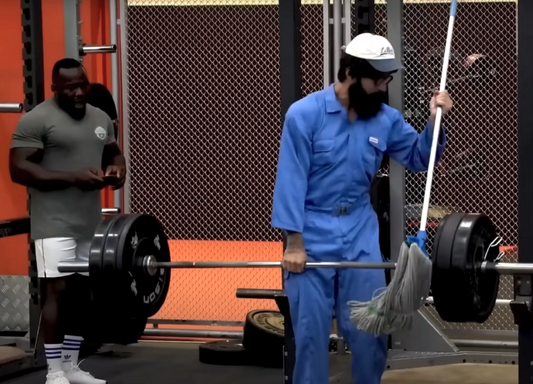 Anatoly cleaner Vladimir Shmondenko deadlifting a heavily loaded barbell in a gym