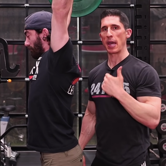Jeff Cavaliere coaching shoulder movement in an ATHLEAN-X gym