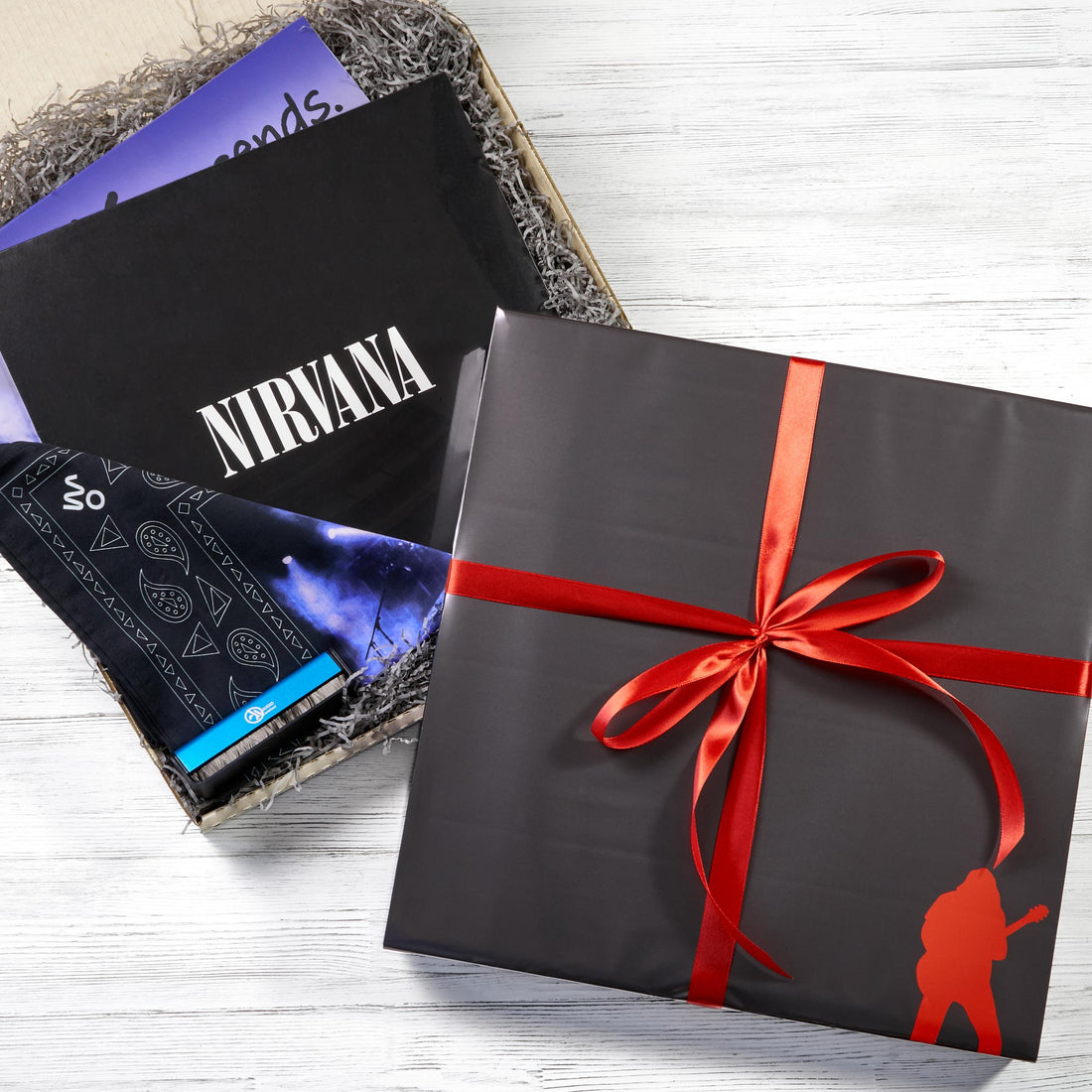 Nirvana music gift box with a dark ribboned package, band lettering and a folded black accessory
