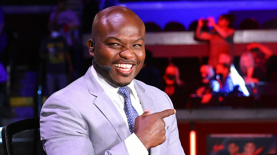 Timothy Bradley smiling during a boxing broadcast in a suit and headset