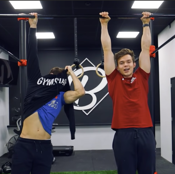 Stan Browney hanging from a pull-up bar during a calisthenics challenge