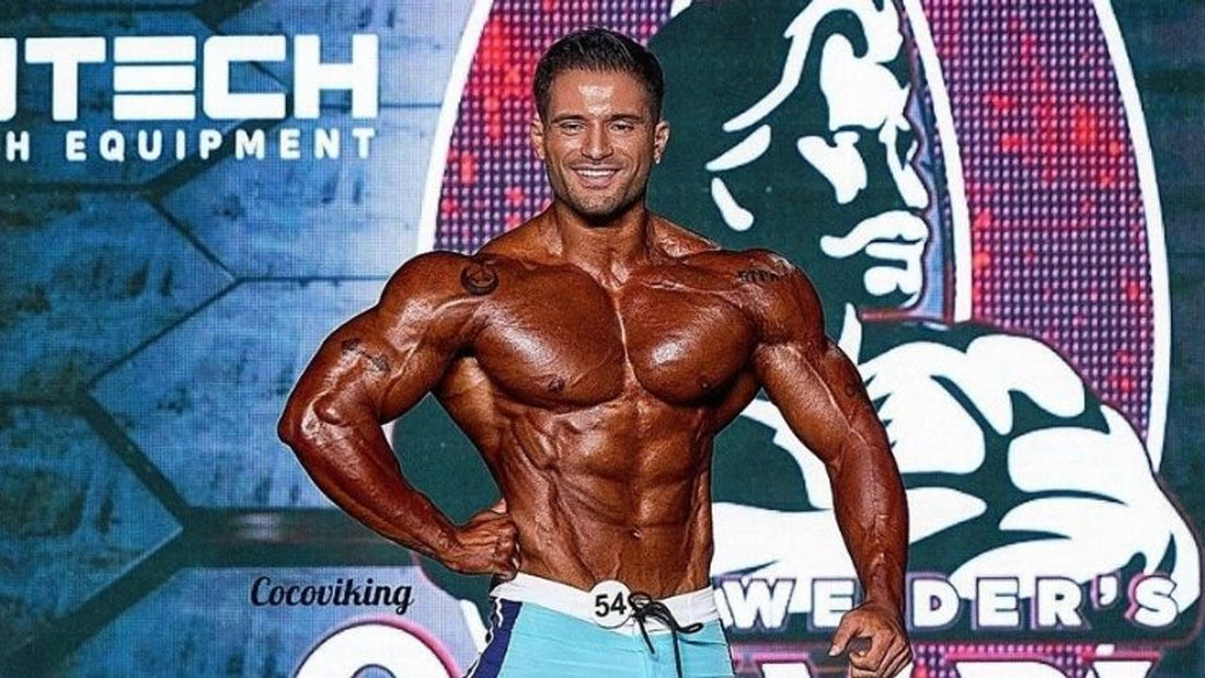 Turkish Men's Physique competitor Burak Ozkul posing at an earlier contest; he finished runner-up to Benquil Marigny at the 2026 Kentucky Bourbon Pro