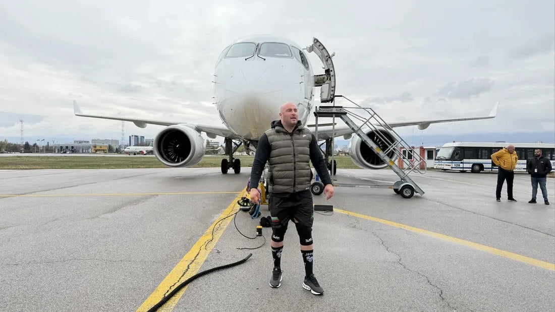 Hristo Muskov standing in front of a passenger jet at Sofia Airport during preparations for an airplane-pull challenge