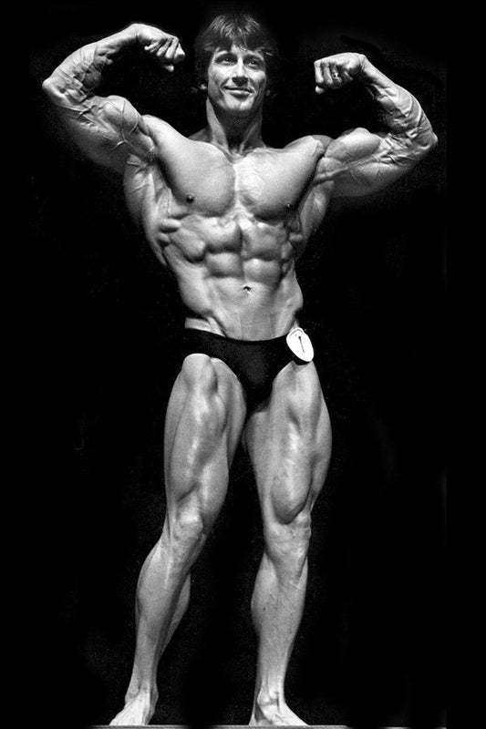 Frank Zane posing with classic bodybuilding symmetry in a vintage black-and-white Mr. Olympia photograph
