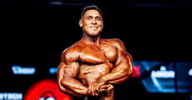 Ramon Dino flexing onstage at the 2026 Mr Olympia Classic Physique finals