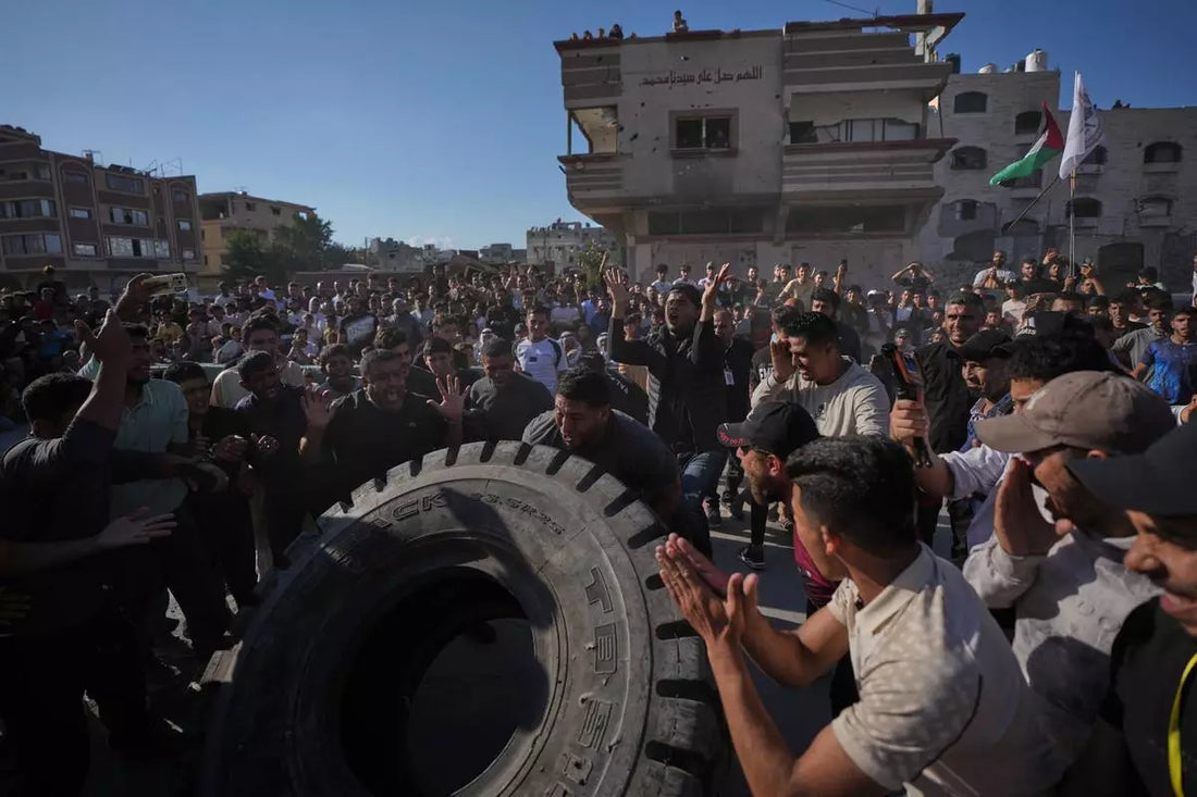 Competitor flipping a giant tractor tire before spectators at the October 2026 Palestine Strongman Championship