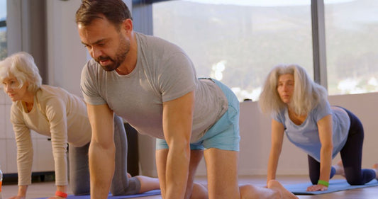Diverse adults exercising together in a group fitness class