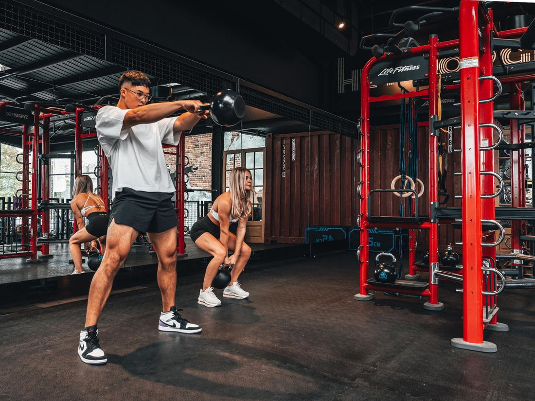 Nicky Holender-inspired functional fitness athlete performing kettlebell training in a gym