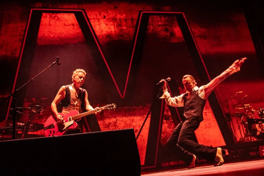 Dave Gahan and Martin Gore of Depeche Mode performing under dramatic red arena lighting