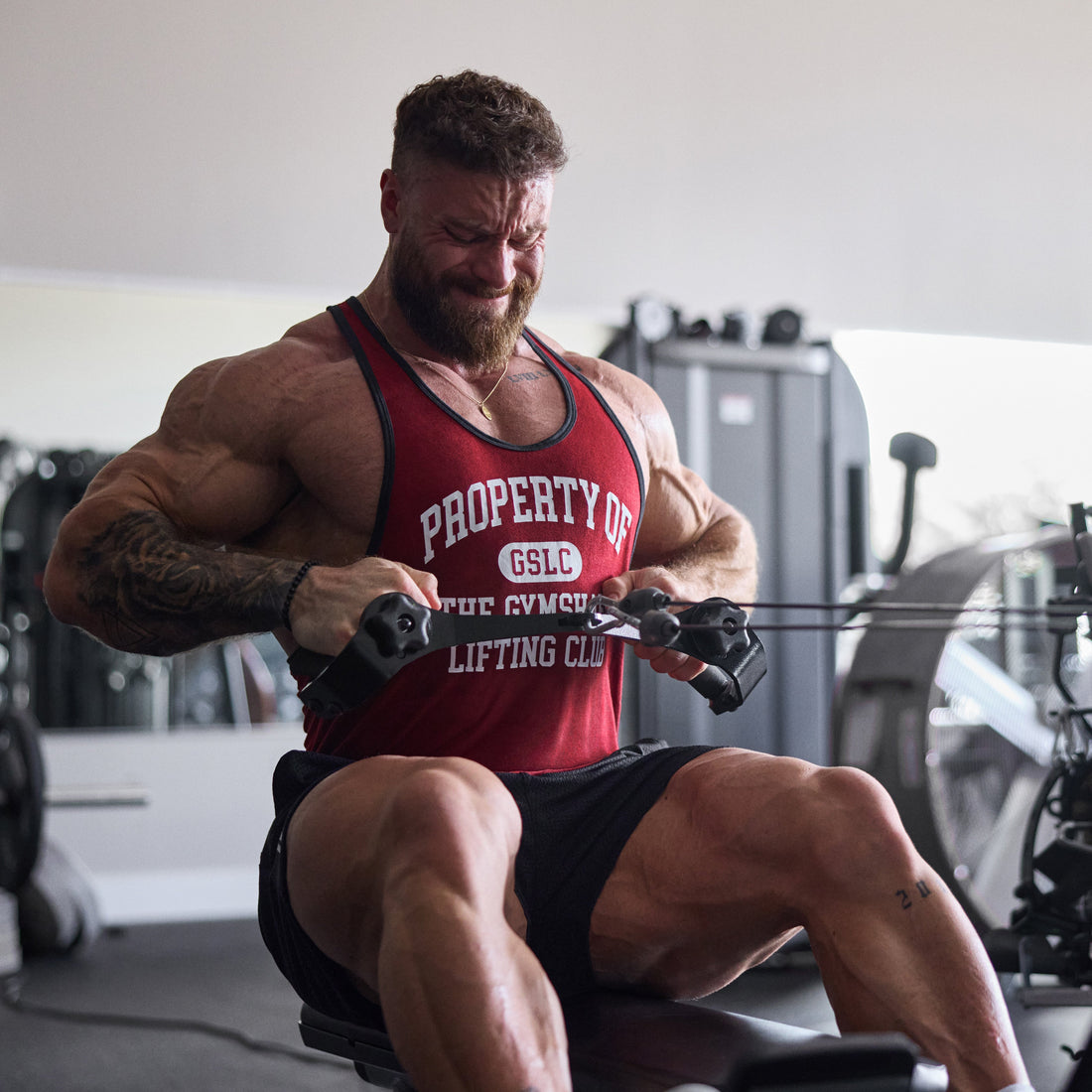 Documentary gym training photographs of Chris Bumstead under load, avoiding product mockups and unrelated athlete imagery.