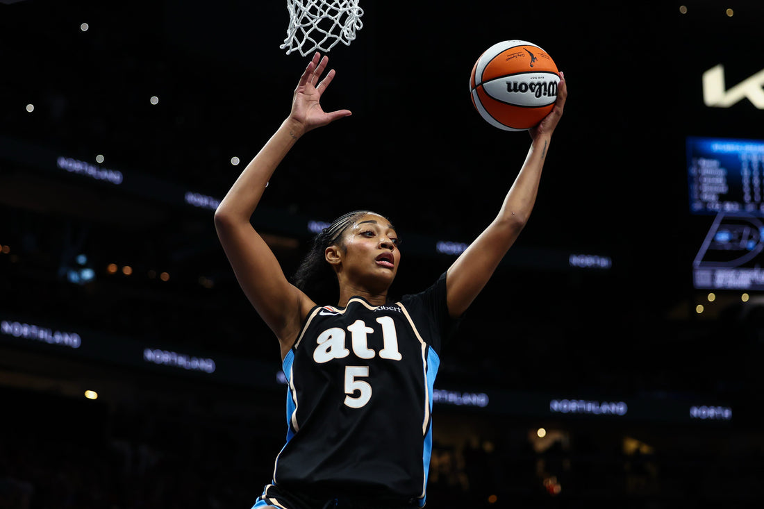 Angel Reese in the Atlanta Dream black and blue No. 5 uniform reaching for a rebound in 2026