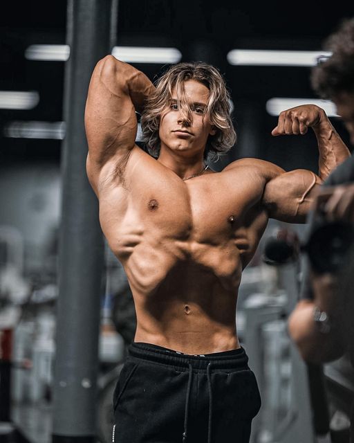 Alex Eubank performing dumbbell strength work in a gym