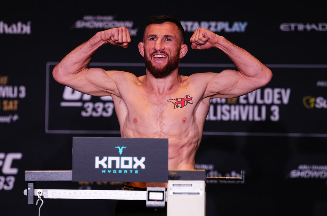 Merab Dvalishvili flexes on the scale at UFC 333 weigh-ins in Abu Dhabi on October 23, 2026