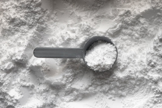 Close-up of glycine powder in a measuring scoop