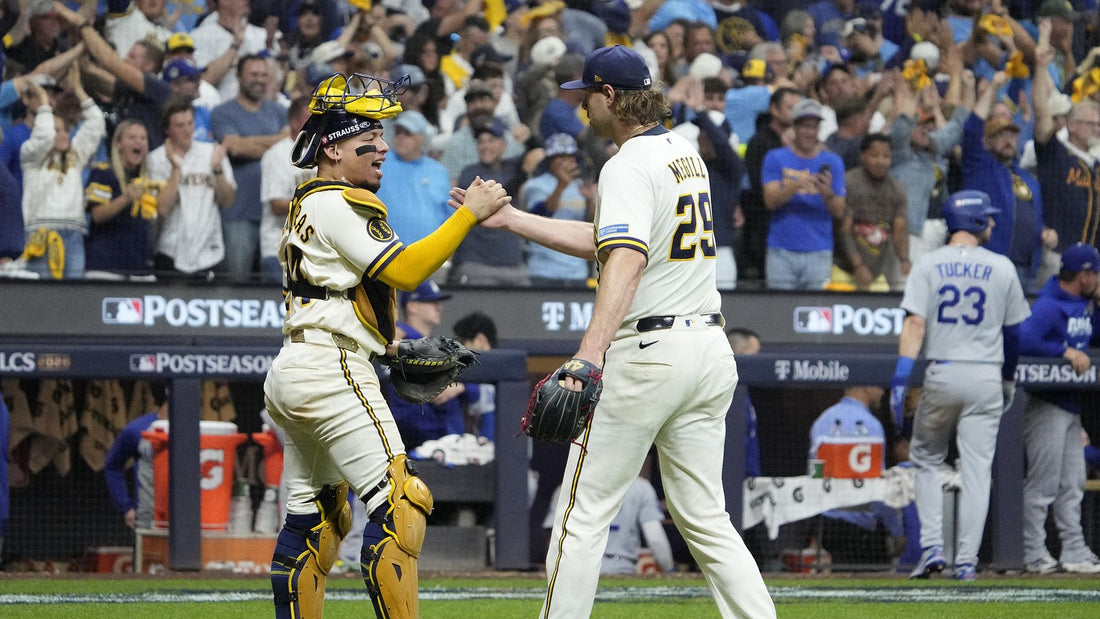 Trevor Megill and William Contreras celebrate together in Milwaukee Brewers uniforms during the 2026 postseason