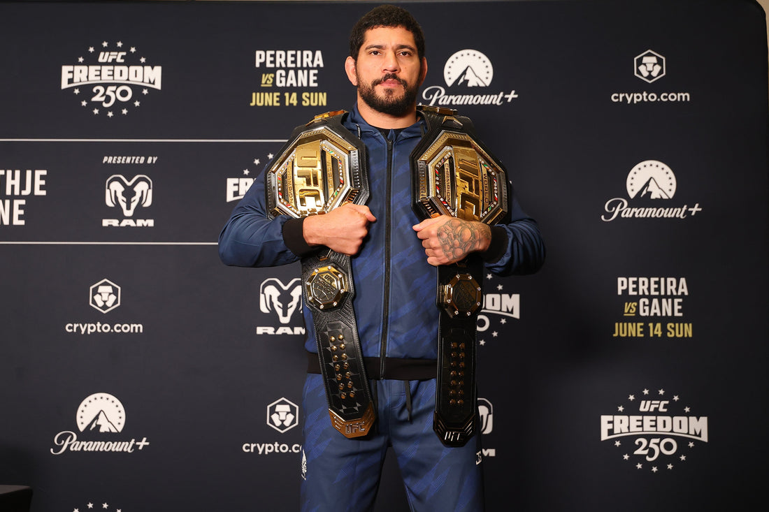 Alex Pereira at a June 2026 UFC media event with championship belts before his heavyweight debut