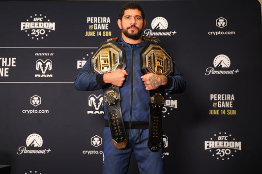 Alex Pereira at a June 2026 UFC media event with championship belts before his heavyweight debut