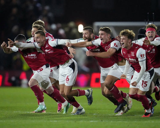 Fleetwood Town players celebrate knocking Arsenal out of the 2026 Carabao Cup