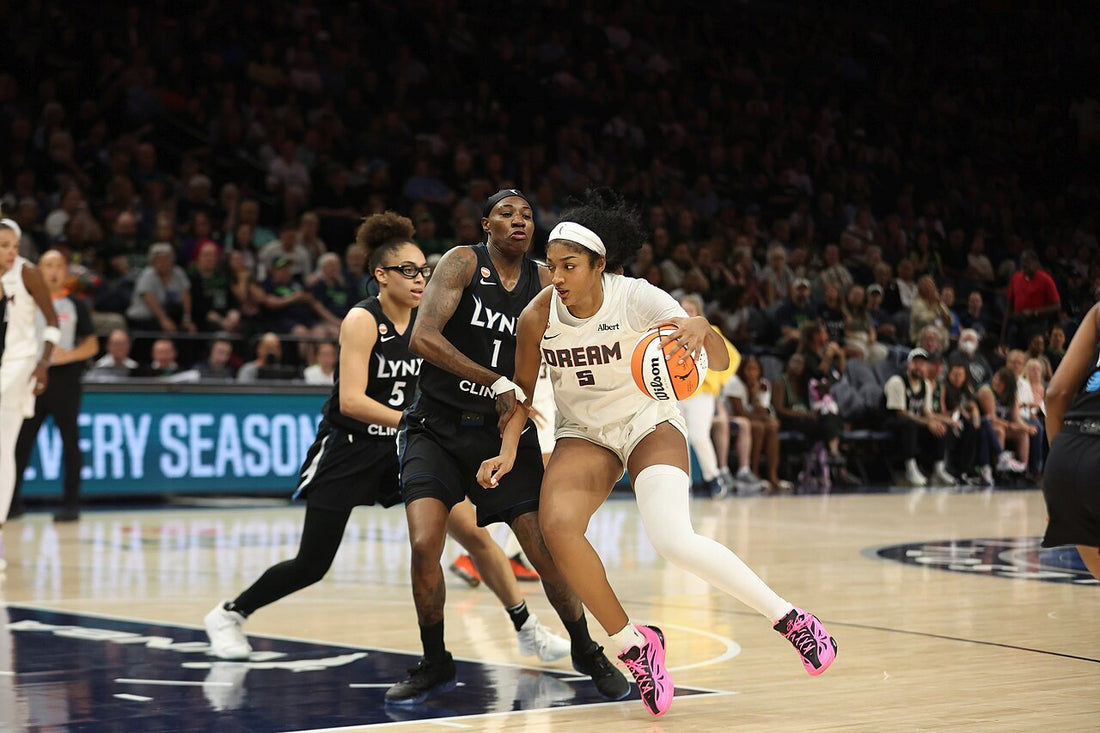 Angel Reese driving in Atlanta Dream white uniform during a May 2026 game against Minnesota