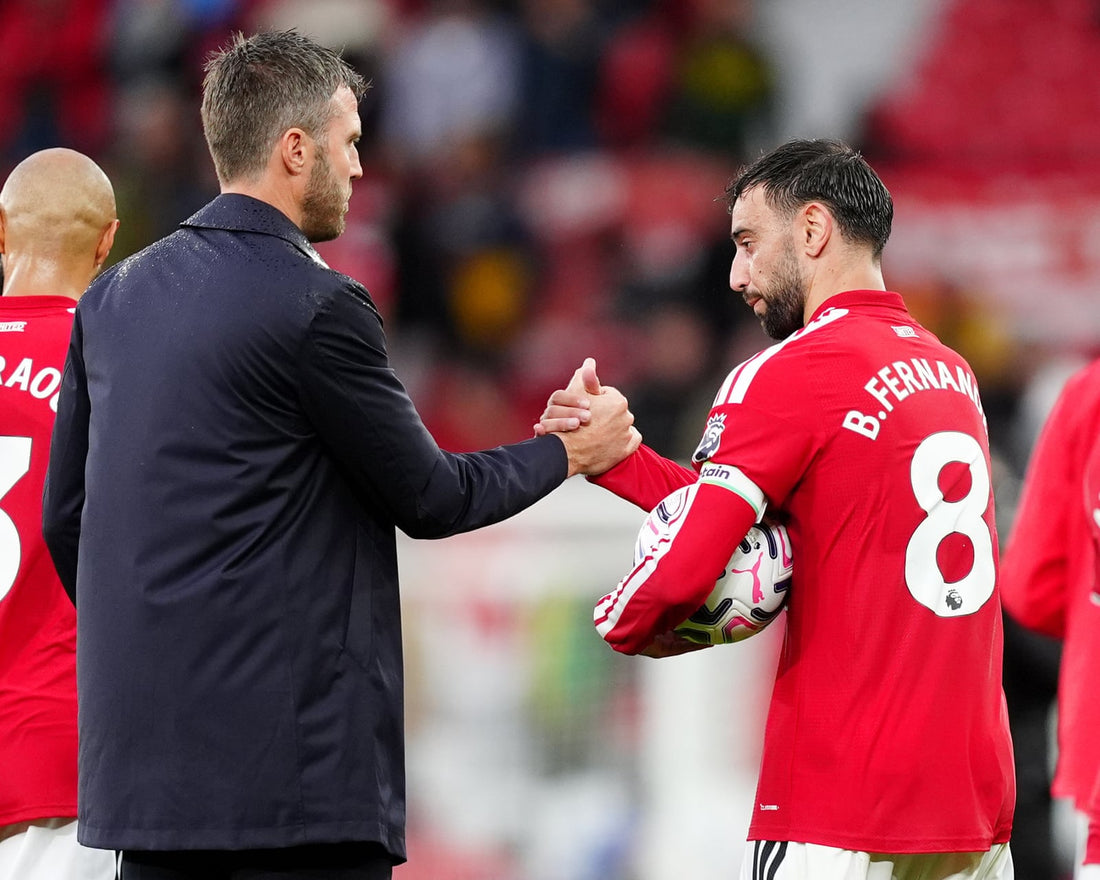 Bruno Fernandes and Michael Carrick greet one another at Manchester United during the 2026 season